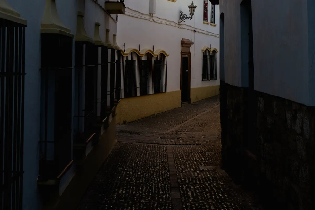 Narrow street with whitewashed houses in an Andalusian old town, illustrative image