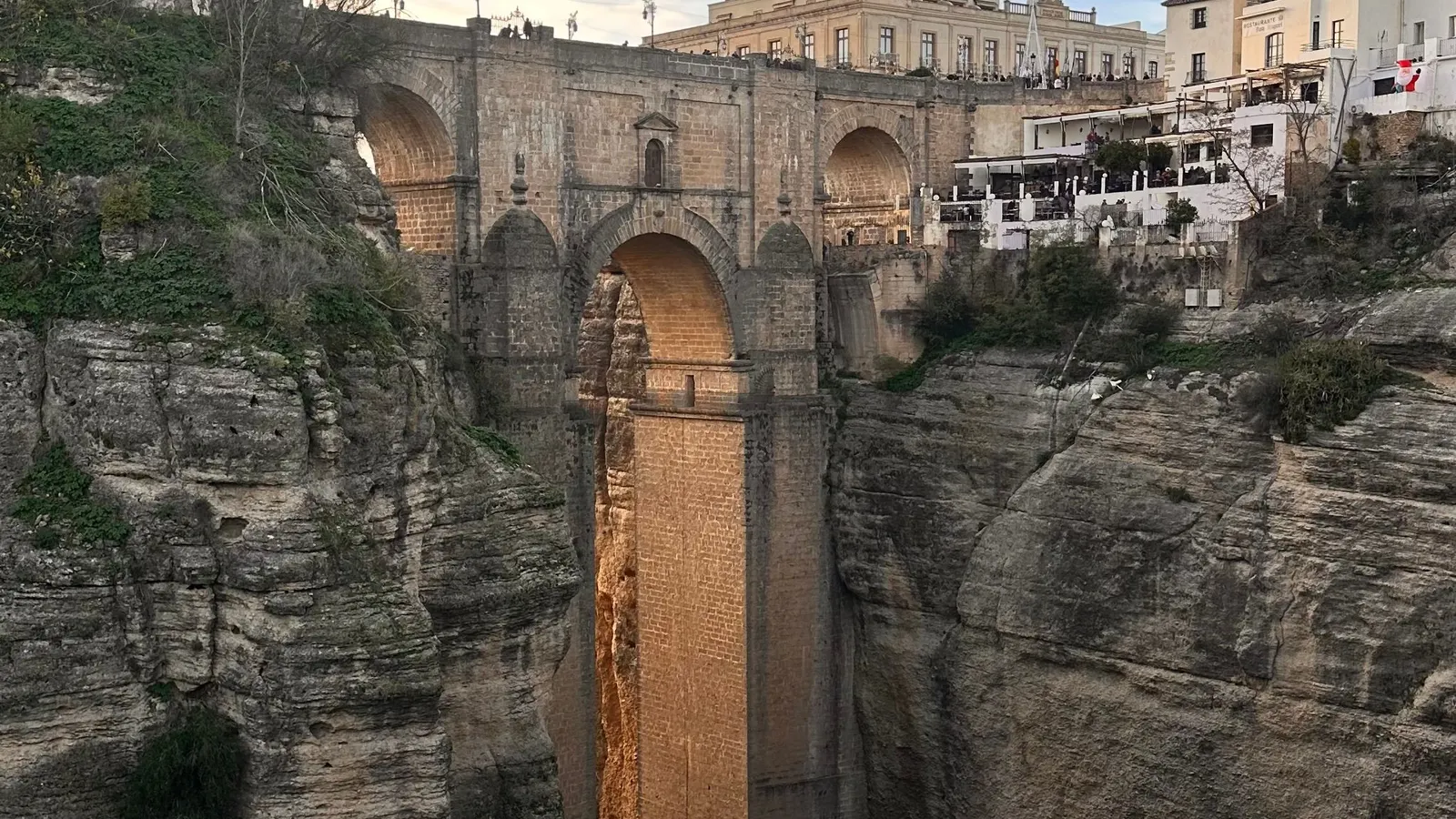 The Puente Nuevo bridge in Ronda seen from the bottom of the Tajo gorge, with the town perched on the edge of the ravine